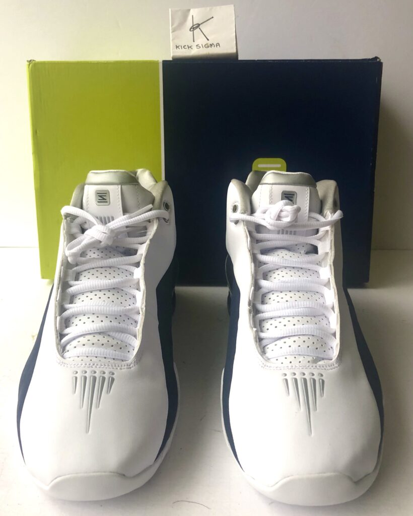 The Nike Shox BB4, white, navy "Olympic" colorway, front view. 
