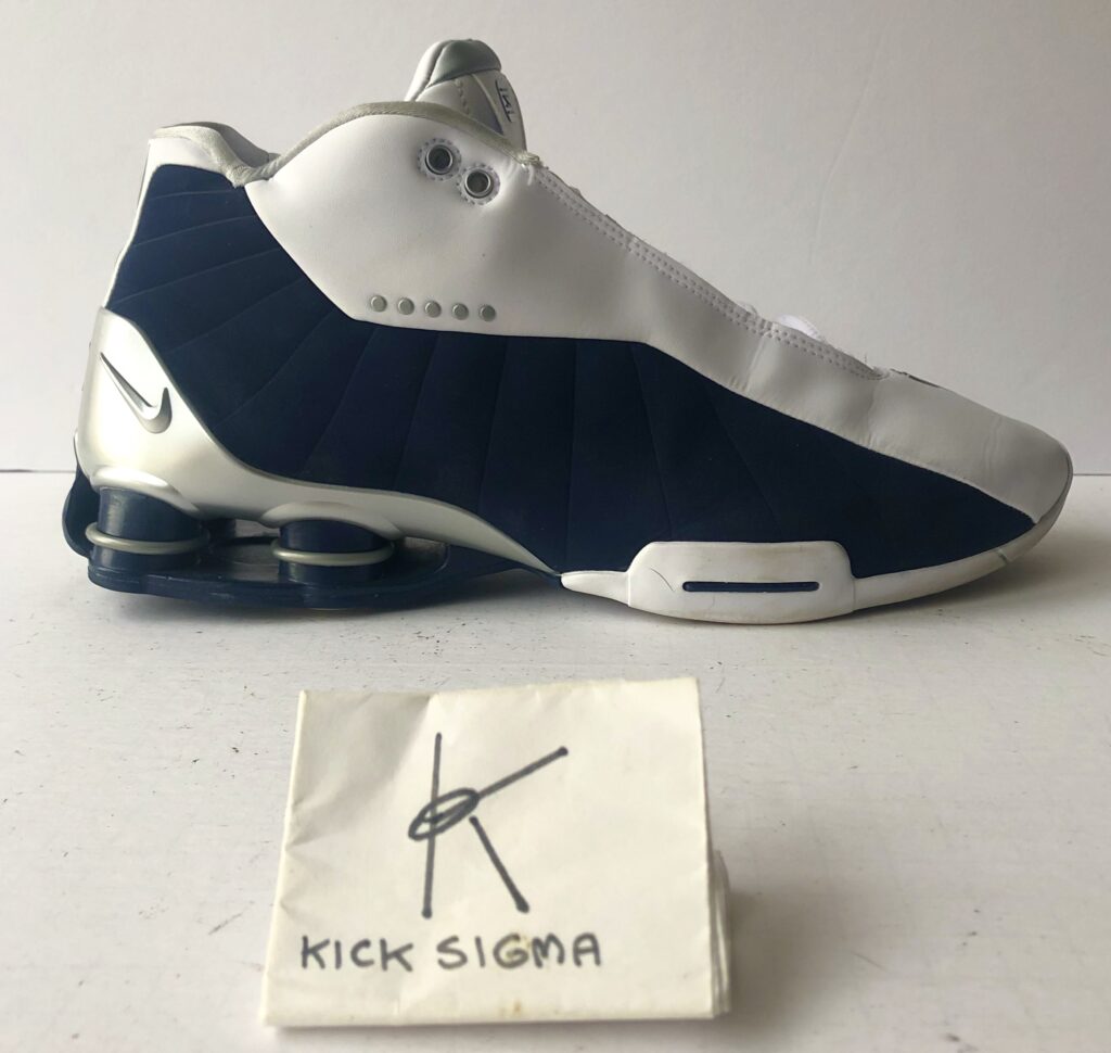 The Nike Shox BB4, white, navy "Olympic" colorway, lateral view. 