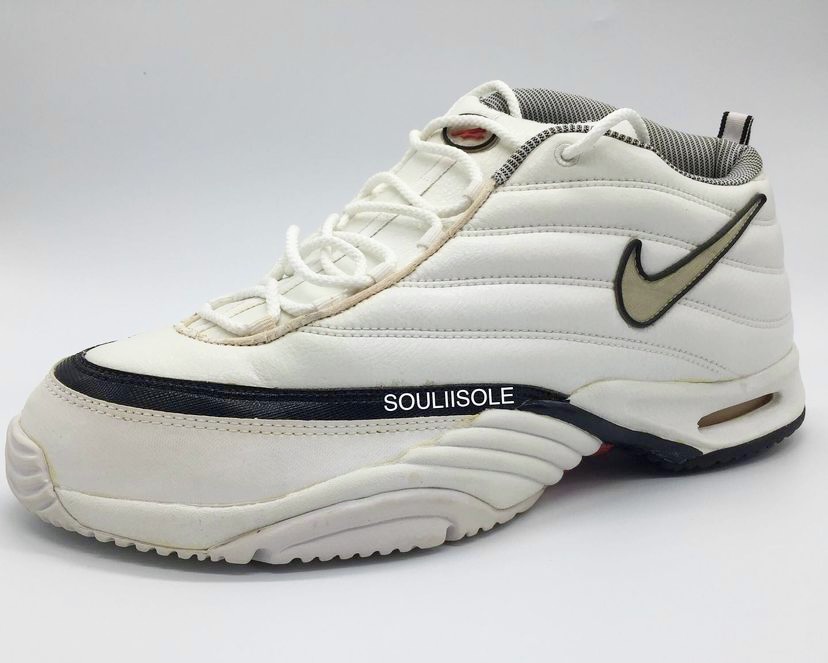 The Nike Air Assailant in the white/metallic silver/black/comet red colorway, lateral view. 