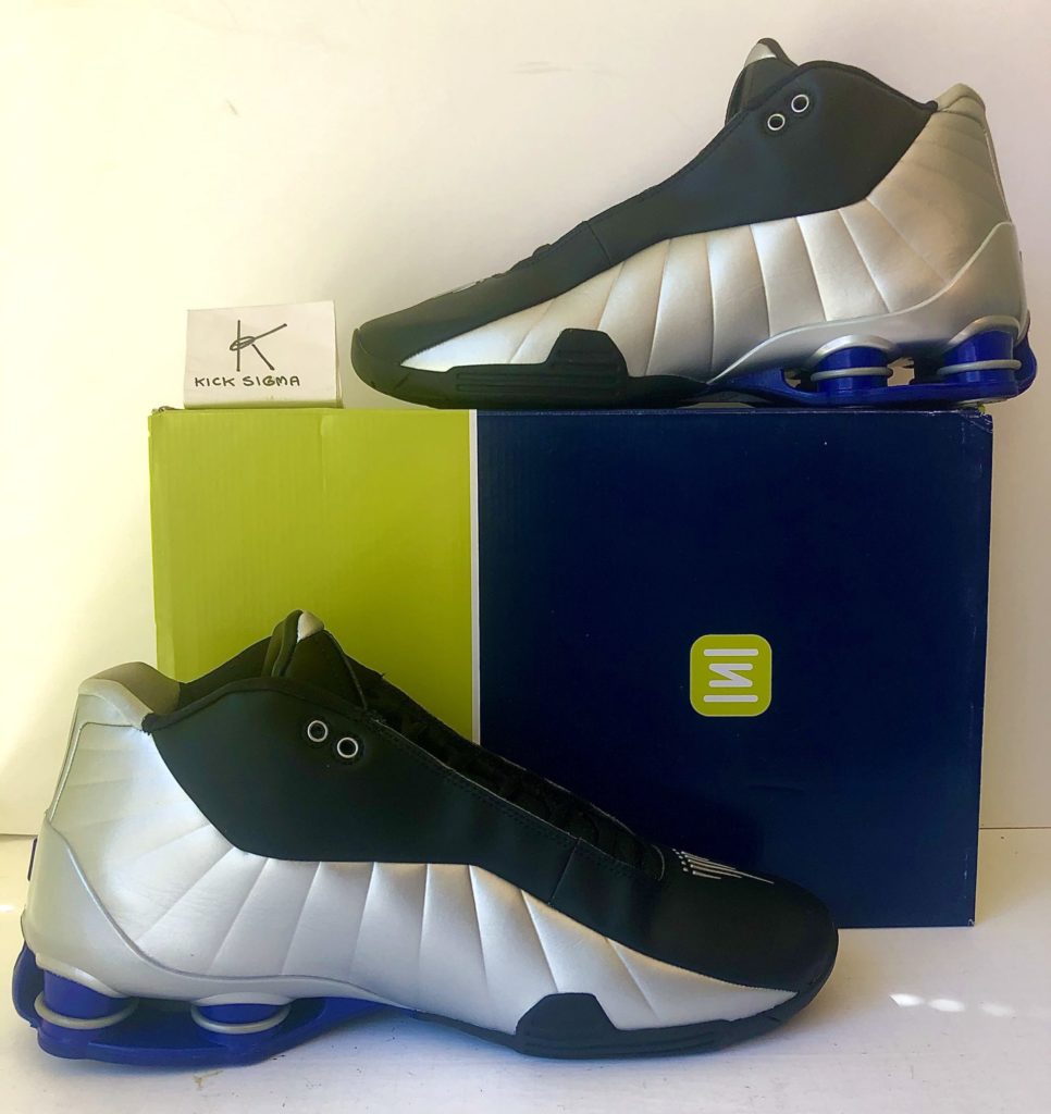 The Nike Shox BB4, black, silver, lapis colorway, medial view. 