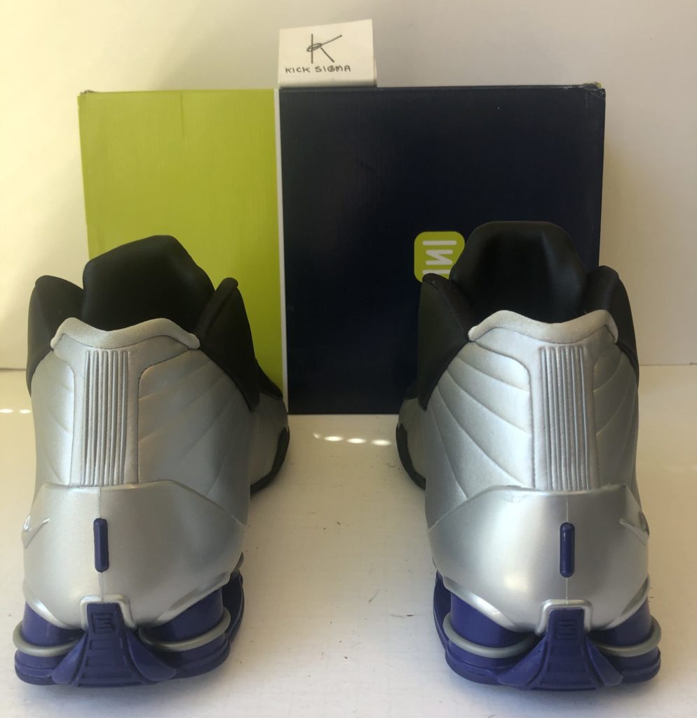 The Nike Shox BB4, black, silver, lapis colorway, rear view. 