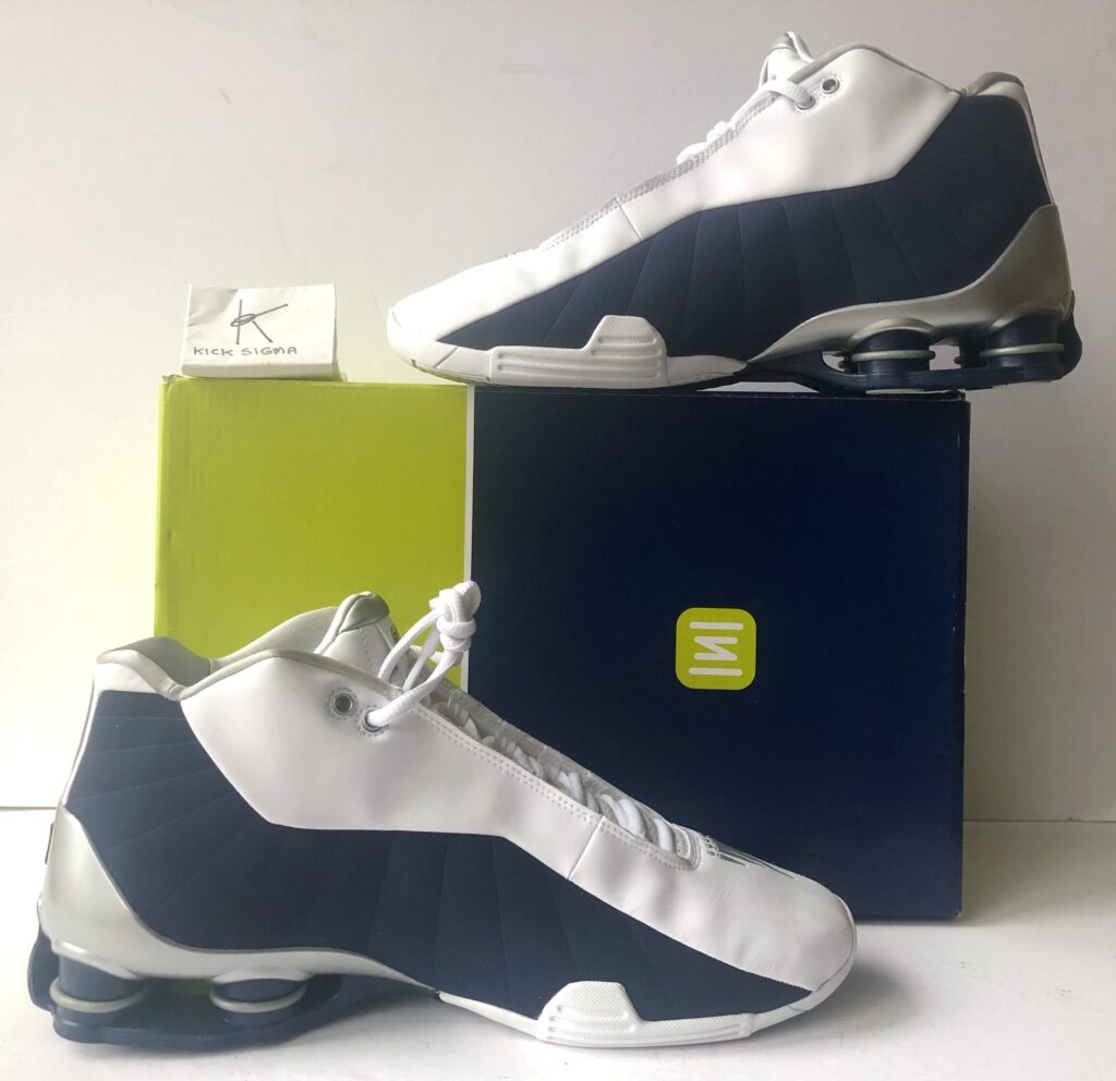 The Nike Shox BB4, white, navy "Olympic" colorway, medial view. 