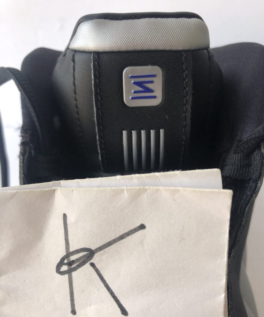 The Nike Shox BB4, black, silver, lapis colorway, tongue. 